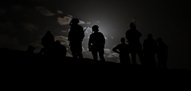 Silhouette photo of military members.