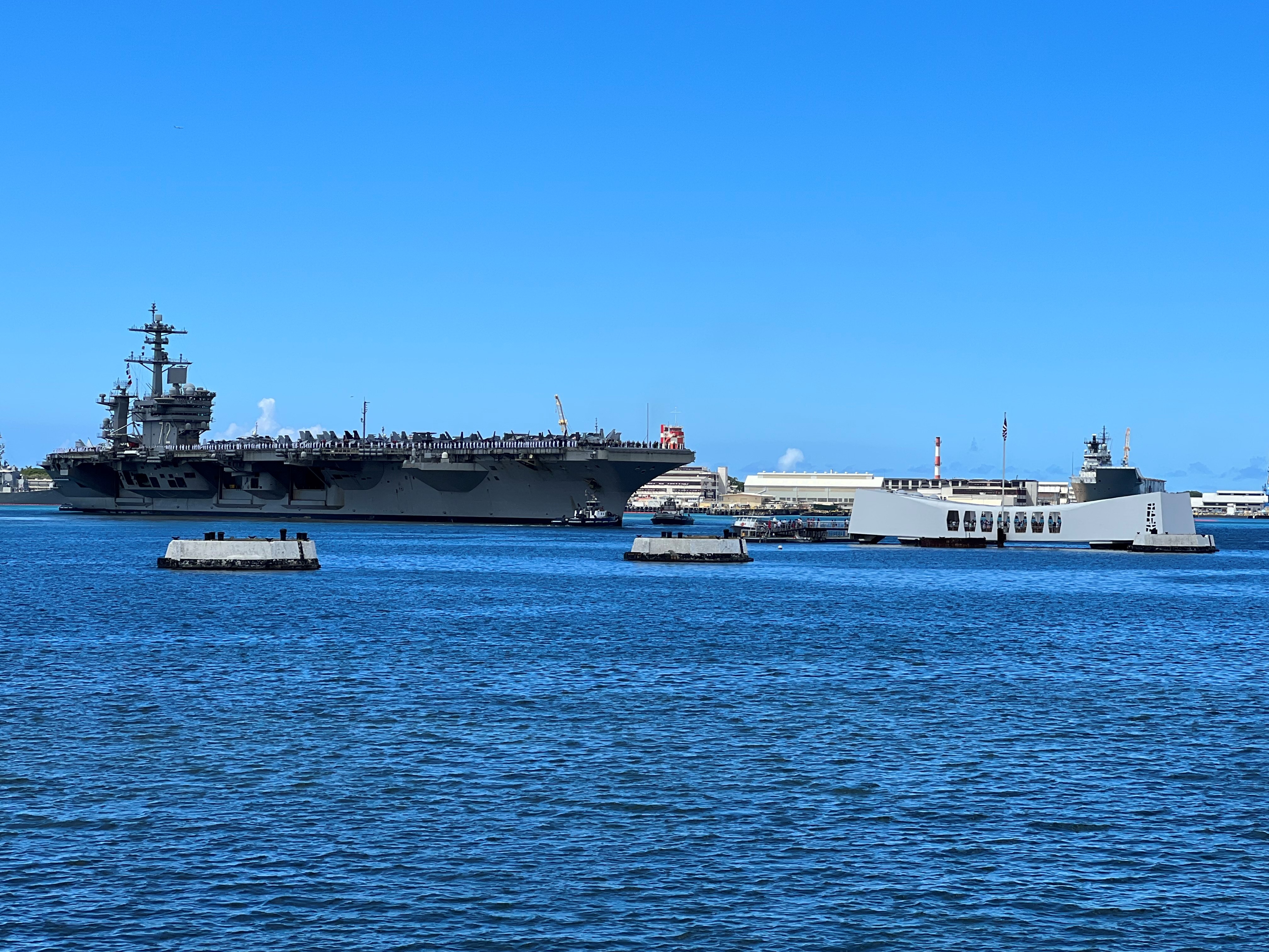 Image of the Nimitz-class aircraft carrier USS Abraham Lincoln (CVN 72) passing the USS Arizona Memorial in Pearl Harbor, Hawaii, during Rim of the Pacific 2022. (DISA photo by Army Sgt. 1st Class Derek D. Olson)