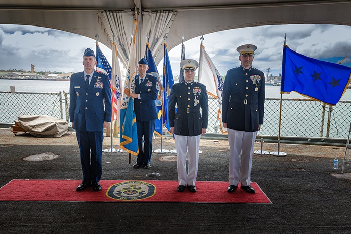 Image of Air Force Lt. Gen. Robert J. Skinner, Defense Information Systems Agency director and Joint Force Headquarters-Department of Defense Information Network commander, Marine Corps Col. Matthew R. Simmons, outgoing DISA Pacific Command commander, and Marine Corps Col. Jared C. Voneida, incoming DISA Pacific Command commander, stand at attention as the change of command ceremony begins on July 15 aboard USS Missouri at Ford Island, Hawaii. Photo by Parish M. Kaleiwahea, DISA/Released.