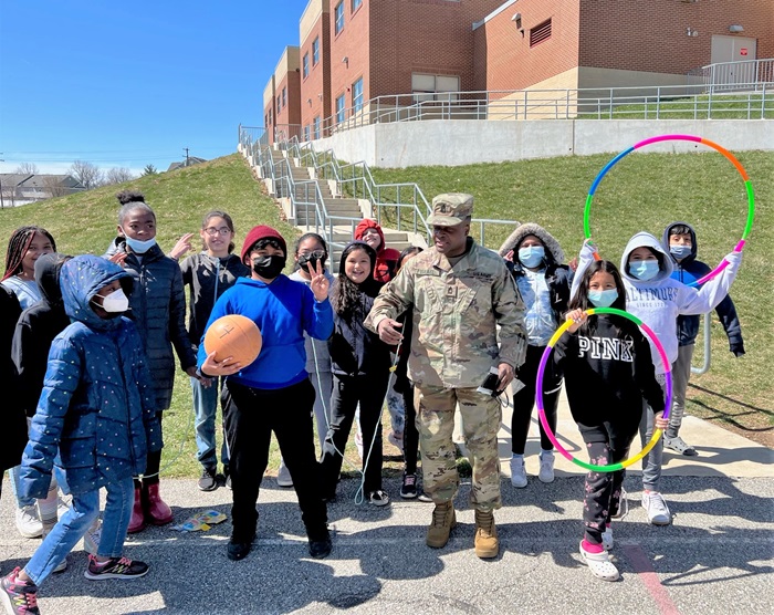 Army Master Sgt. Evens Israel poses with Deep Run Elementary School students using sporting equipment donated by DISA’s Wellness Program