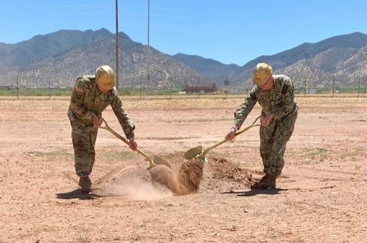 Army Col. Jarrod Moreland, Fort Huachuca garrison commander, left, and Navy Capt. Robert Matthias, commander, Joint Interoperability Test Command, Defense Information Systems Agency, right, break ground for the Joint Interoperability Test Command’s future Test and Evaluation Facility, May 17, 2022, Fort Huachuca, Arizona. Once completed, the testing facility will offer multiple net-centric research, development, test and evaluation capabilities designed to meet the unique demands of the JITC mission in support of national security and the warfighter. (DOD photo by the Defense Information Systems Agency Office of Strategic Communication and Public Affairs)