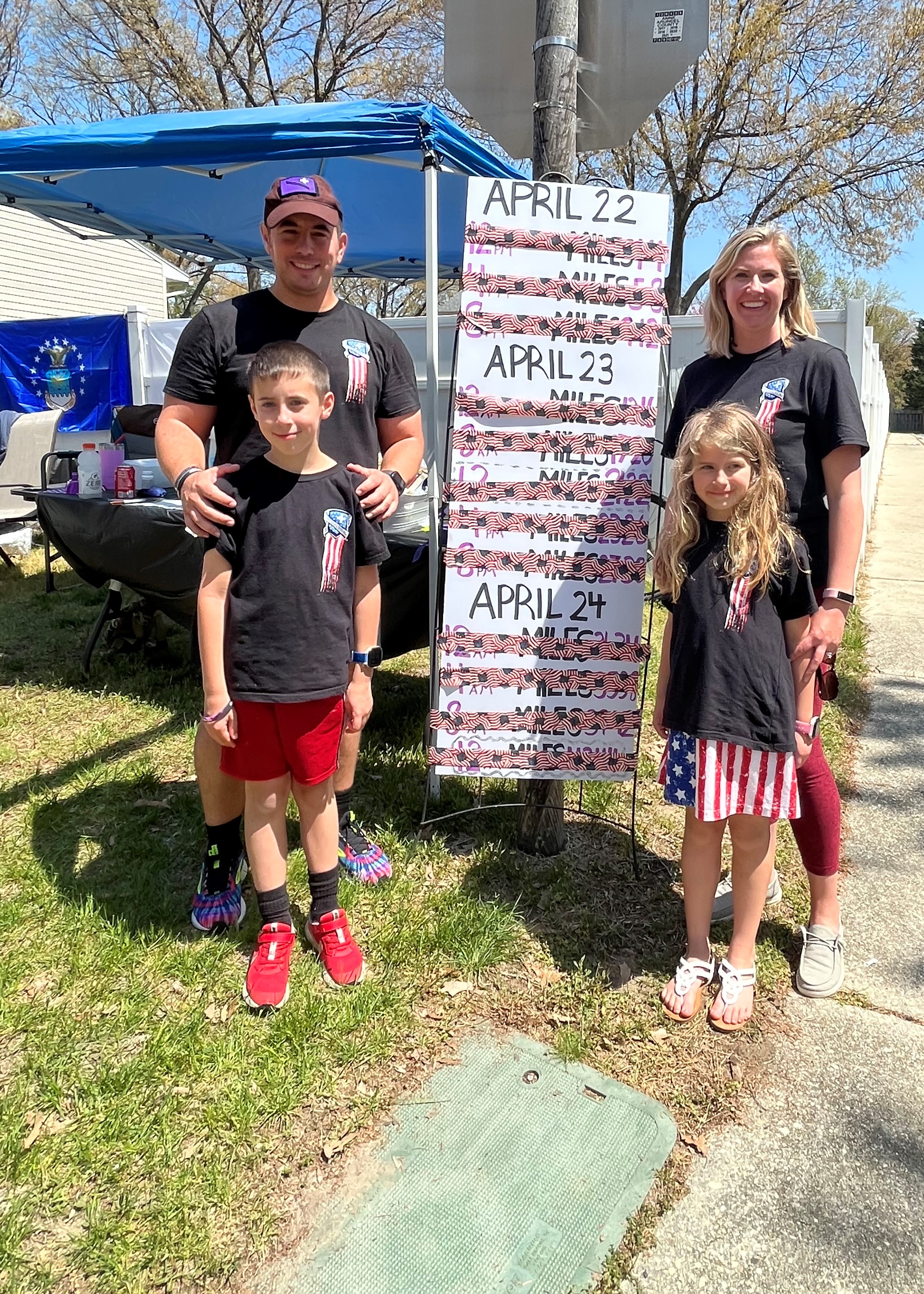 Kyle Butters’ wife and two kids help tick off his 12 loops with flag duct tape during the 22 Miles to Break Boundaries event April 22-24 in Pasadena, Maryland.