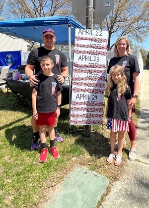 Kyle Butters’ wife and two kids help tick off his 12 loops with flag duct tape during the 22 Miles to Break Boundaries event April 22-24 in Pasadena, Maryland.