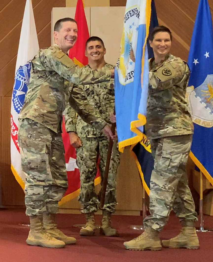 Lt. Gen. Robert J. Skinner, DISA Director and JFHQ-DODIN Commander, hands Diane E. Klein change of command flag.