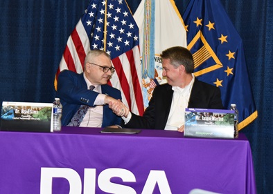 President, Capitol Technology University, Dr. Brad Sims, left, shakes hands with DISA Digital Capabilities and Security Center Director and Acquisition Executive, Jason Martin, during Education Partnership Agreement signing ceremony June 24 at Fort George G. Meade. (U.S. DOD photo by Thomas L. Burton, DISA/Released).