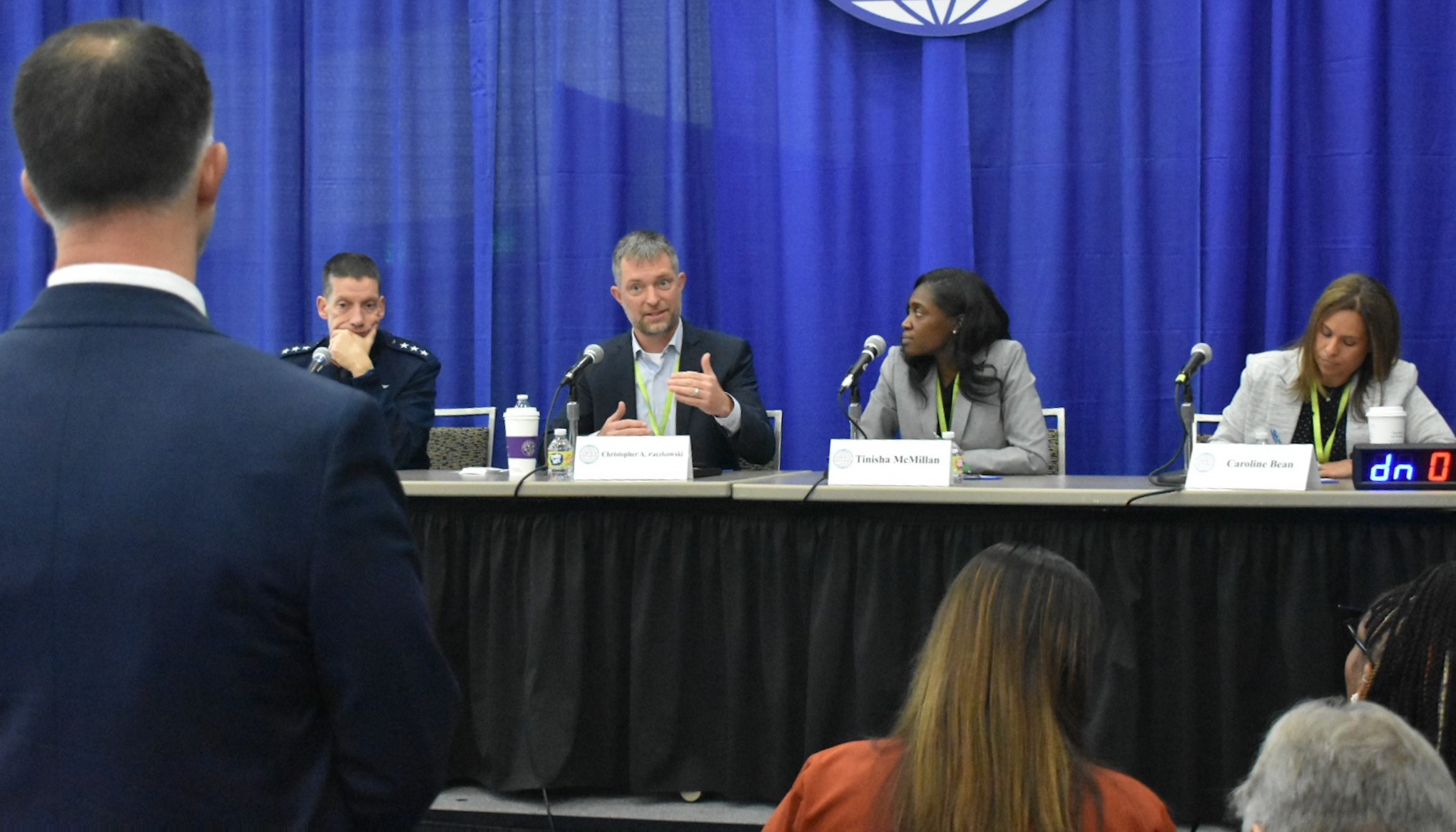 Photo of DISA's Small Business Elevator Pitch competition panel, Lt. Gen. Skinner, Christopher Paczkowski, Tanisha McMillan, Caroline Bean, with Paczkowski providing feadback.