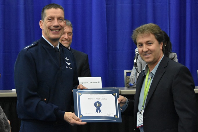 Air Force Lt. Gen. Robert J. Skinner, director of Defense information Systems Agency and JFHQ-DODIN commander, presents Bradley Rainbolt with the first-place certificate from the DISA’s Small Business Elevator Pitch contest.