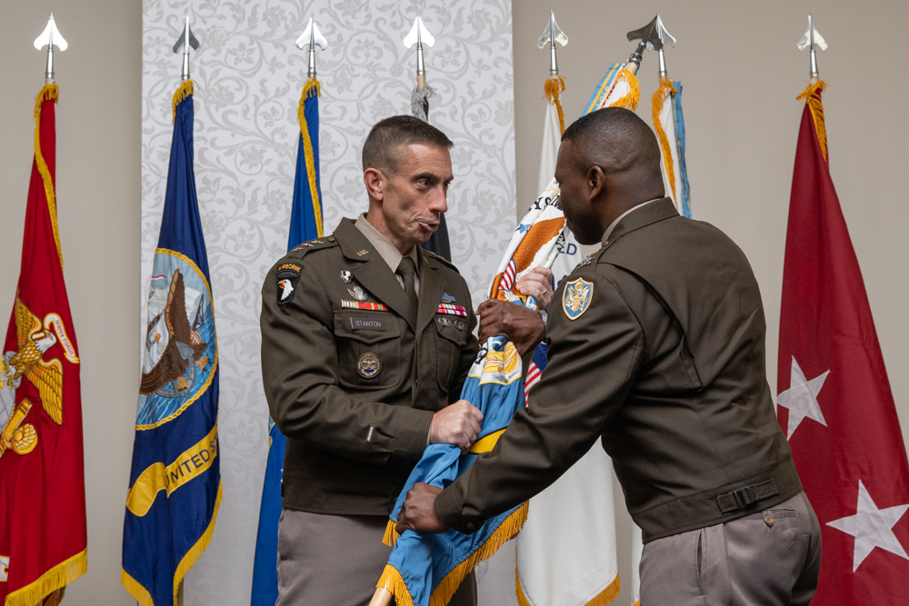 Army Lt. Gen. Paul T. Stanton, on the left, passes the DISA flag to Army Col. Duane M. Williams.